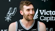 Jul 7, 2025; San Antonio, Texas, USA; San Antonio Spurs center Luke Kornet (7) smiles during his first press conference with the team at Victory Capital Performance Center.
