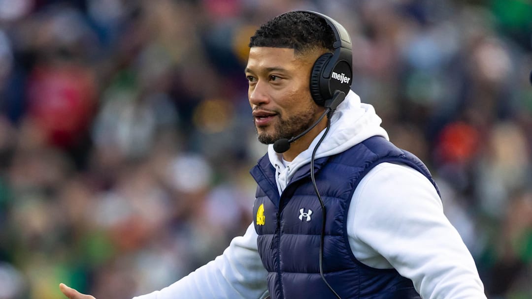 Nov 22, 2025; South Bend, Indiana, USA; Notre Dame Fighting Irish head coach Marcus Freeman celebrates with players after scoring against the Syracuse Orange during the first half at Notre Dame Stadium.