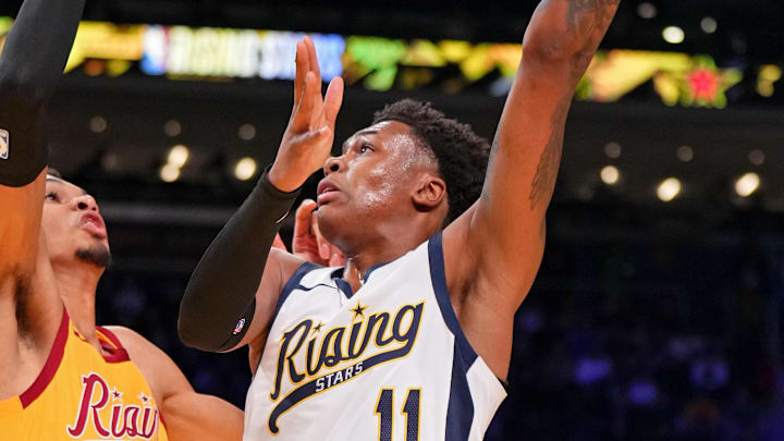 Feb 16, 2024; Indianapolis, Indiana, USA; Team Detlef forward Tyler Smith (11) of the G League Ignite shoots the ball against Team Pau center Victor Wembanyama (1) of the San Antonio Spurs during a Rising Stars semifinal game at Gainbridge Fieldhouse. Mandatory Credit: Kyle Terada-Imagn Images