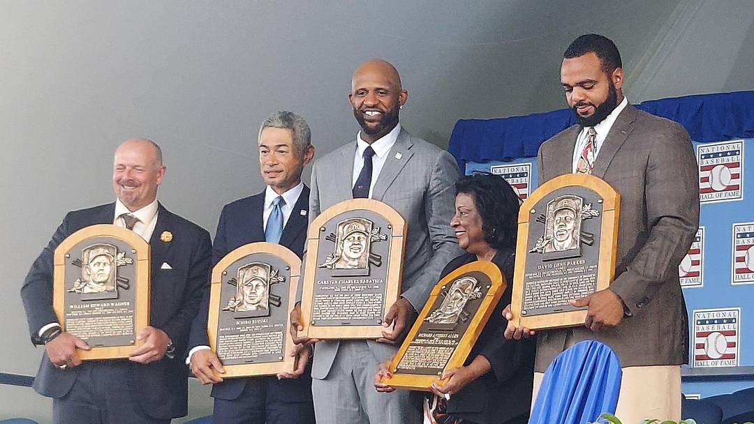 Inductees Billy Wagner, Ichiro Suzuki and CC Sabathia, Willa Allen, widow of Dick Allen, and David Parker II, son of Dave Parker (from left) pose with plaques at the conclusion of the Baseball Hall of Fame's annual induction ceremony Sunday, July 27, 2025, at Clark Sports Center in Cooperstown, New York.