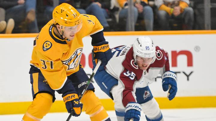 Dec 9, 2025; Nashville, Tennessee, USA;  Colorado Avalanche left wing Victor Olofsson (95) and Nashville Predators defenseman Nick Blankenburg (37) battle for the puck during the first period at Bridgestone Arena. Mandatory Credit: Steve Roberts-Imagn Images