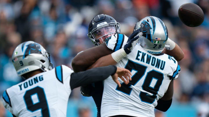 Tennessee Titans linebacker Rashad Weaver (99) puts pressure on Carolina Panthers quarterback Bryce Young (9) as offensive tackle Ikem Ekwonu (79) tries to hold him off during their game at Nissan Stadium in Nashville, Tenn., Sunday, Nov. 26, 2023.