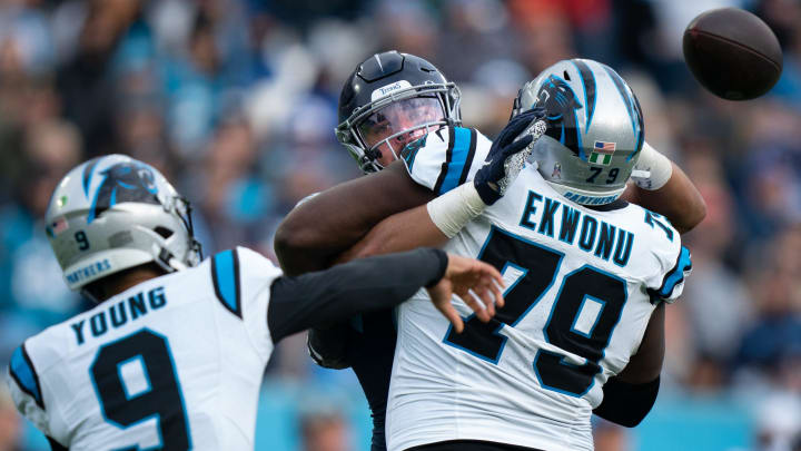 Tennessee Titans linebacker Rashad Weaver (99) puts pressure on Carolina Panthers quarterback Bryce Young (9) as offensive tackle Ikem Ekwonu (79) tries to hold him off during their game at Nissan Stadium in Nashville, Tenn., Sunday, Nov. 26, 2023.