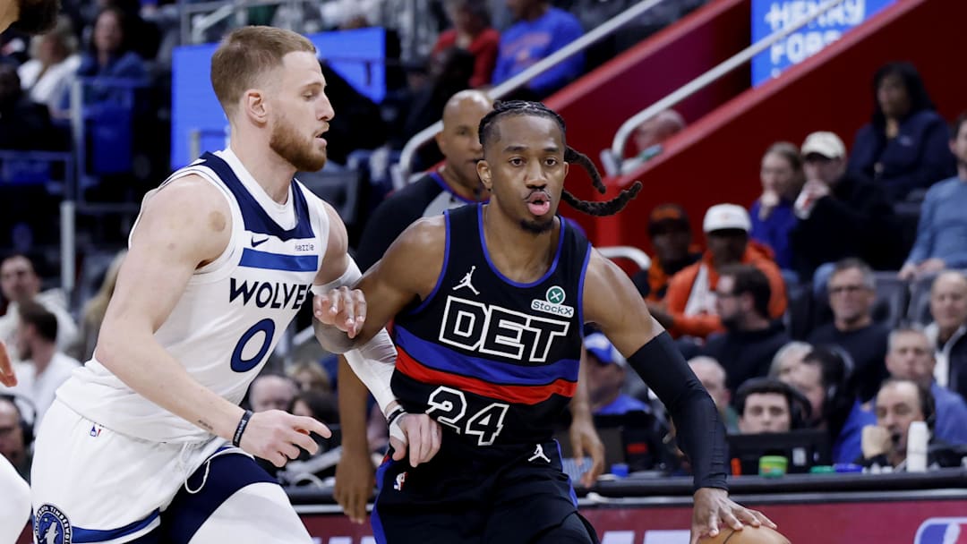 Apr 02, 2026; Detroit, Michigan, USA; Detroit Pistons guard Daniss Jenkins (24) dribbles the ball against Minnesota Timberwolves guard Donte DiVincenzo (0) in the first half at Little Caesars Arena. Mandatory Credit: Rick Osentoski-Imagn Images
