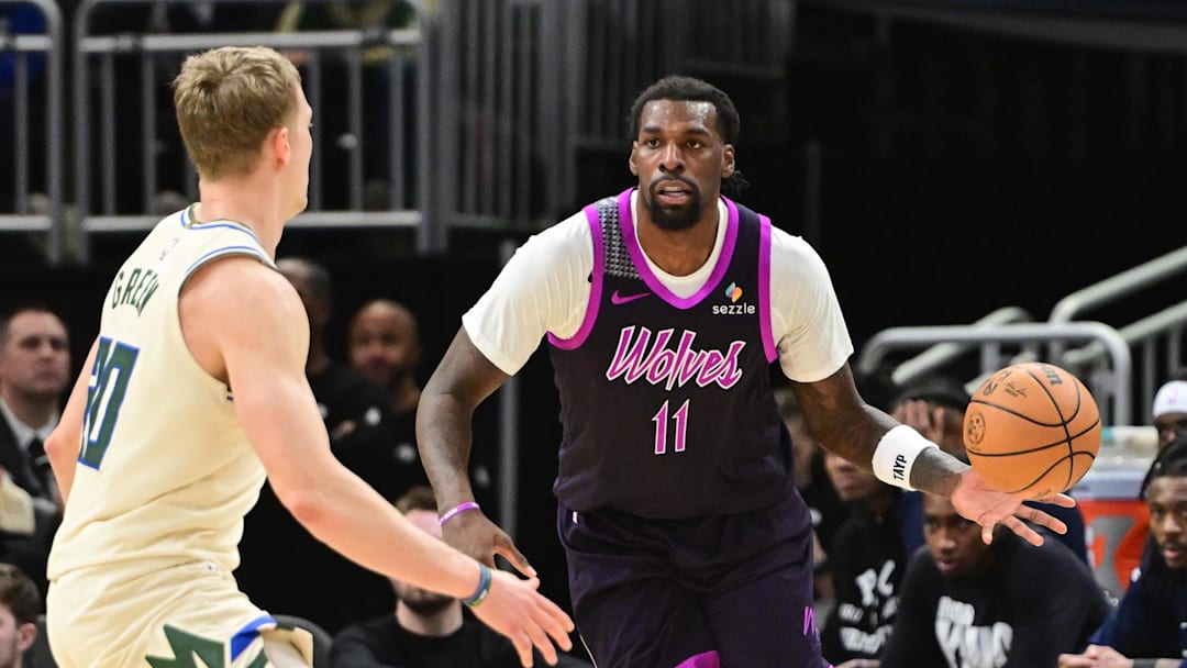 Jan 13, 2026; Milwaukee, Wisconsin, USA; Minnesota Timberwolves center Naz Reid (11) passes the ball away from Milwaukee Bucks guard AJ Green (20) in the third quarter at Fiserv Forum. Mandatory Credit: Benny Sieu-Imagn Images