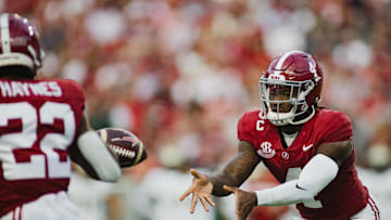 Sep 7, 2024; Tuscaloosa, Alabama, USA; Alabama Crimson Tide quarterback Jalen Milroe (4) passes off the ball to running back Justice Haynes (22) against the South Florida Bulls during the first quarter at Bryant-Denny Stadium. Mandatory Credit: William McLelland-Imagn Images