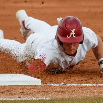 Feb 23, 2024; Tuscaloosa, Alabama, USA; Alabama baserunner Will Hodo slides safely into first on a pickoff attempt during the opening game of the weekend series with Valparaiso at Sewell-Thomas Stadium.