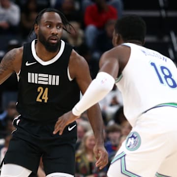 Dec 8, 2023; Memphis, Tennessee, USA; Memphis Grizzlies guard Jaylen Nowell (24) dribbles as Minnesota Timberwolves guard-forward Shake Milton (18) defends during the second half at FedExForum. Mandatory Credit: Petre Thomas-Imagn Images