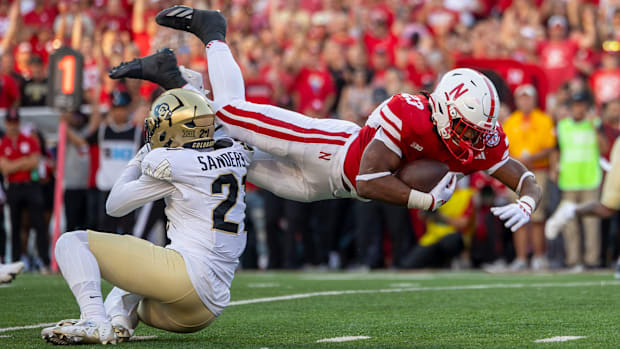 Nebraska running back Dante Dowdell rushes for a 13-yard gain in the first quarter against Colorado.