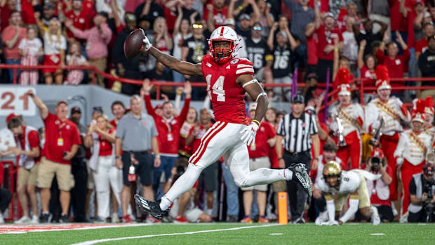 Nebraska running back Rahmir Johnson holds the ball out as he crosses the goal line on a 18-yard touchdown reception.