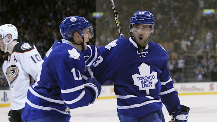 Mar 24, 2016; Toronto, Ontario, CAN; Toronto Maple Leafs forward Zach Hyman (11) congratulates forward Nazem Kadri (43) on scoring the winning goal against the Anaheim Ducks at the Air Canada Centre. Toronto defeated Anaheim 6-5 in overtime. Mandatory Credit: John E. Sokolowski-Imagn Images