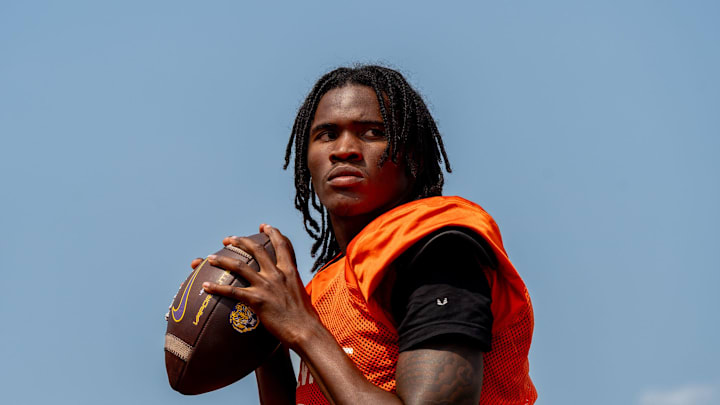Quarterback Bryce Underwood prepares to throw a pass during a team practice at the Belleville High School football field in Belleville on Wednesday, Aug. 14, 2024.