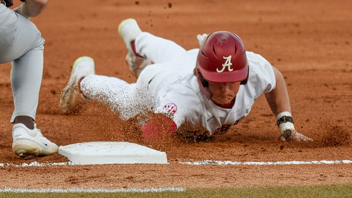 Feb 23, 2024; Tuscaloosa, Alabama, USA; Alabama baserunner Will Hodo slides safely into first on a pickoff attempt during the opening game of the weekend series with Valparaiso at Sewell-Thomas Stadium.