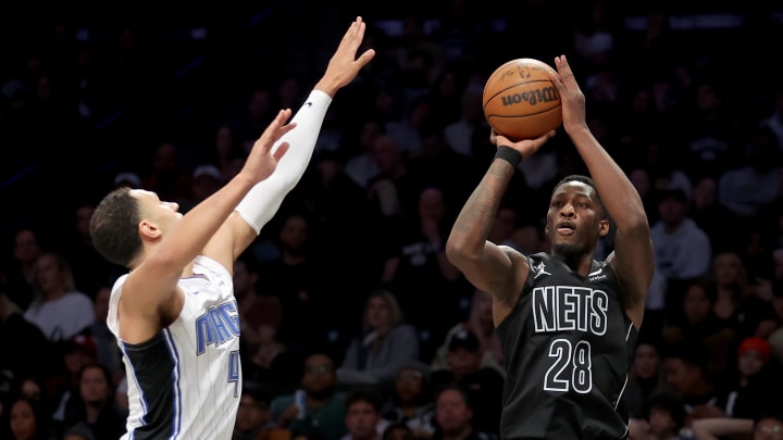 Apr 7, 2023; Brooklyn, New York, USA; Brooklyn Nets forward Dorian Finney-Smith (28) shoots a three point shot against Orlando Magic guard Jalen Suggs (4) during the third quarter at Barclays Center. Mandatory Credit: Brad Penner-USA TODAY Sports