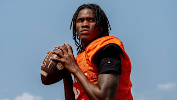 Quarterback Bryce Underwood prepares to throw a pass during a team practice at the Belleville High School football field in Belleville on Wednesday, Aug. 14, 2024.