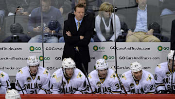 Feb 4 2013; Denver, CO, USA; Dallas Stars head coach Glen Gulutzan on his bench during the first period of the game against the Colorado Avalanche at the Pepsi Center. Mandatory Credit: Ron Chenoy-Imagn Images