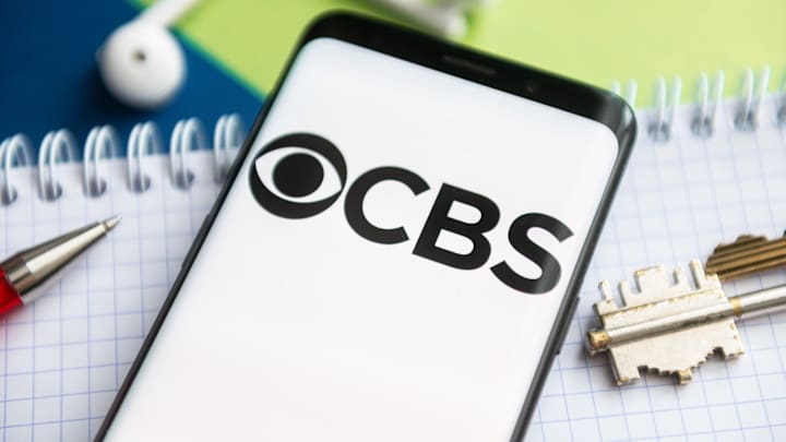In this photo illustration, a CBS logo seen displayed on a...