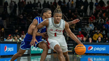 Orchard Lake Saint Mary’s Trey McKenney (1) dribbles through IMG Academy’s Darius Acuff (5) at Oakland University in Rochester on Thursday, Jan. 9, 2025. He suffered a broken bone in his hand during this game which kept him out of the lineup for nearly a month.