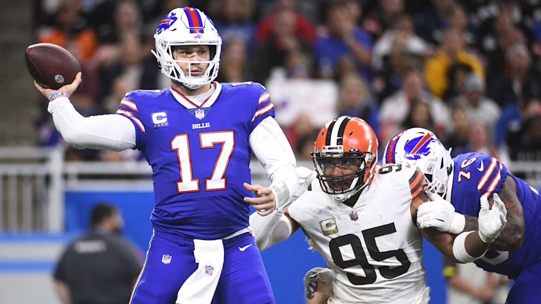 Buffalo Bills QB Josh Allen drops back to throw the ball as Cleveland Browns DE Myles Garrett chases.
