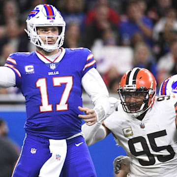 Buffalo Bills QB Josh Allen drops back to throw the ball as Cleveland Browns DE Myles Garrett chases.