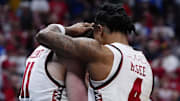 Wisconsin players embrace following a loss to BYU in the second round of the NCAA Tournament Saturday night.