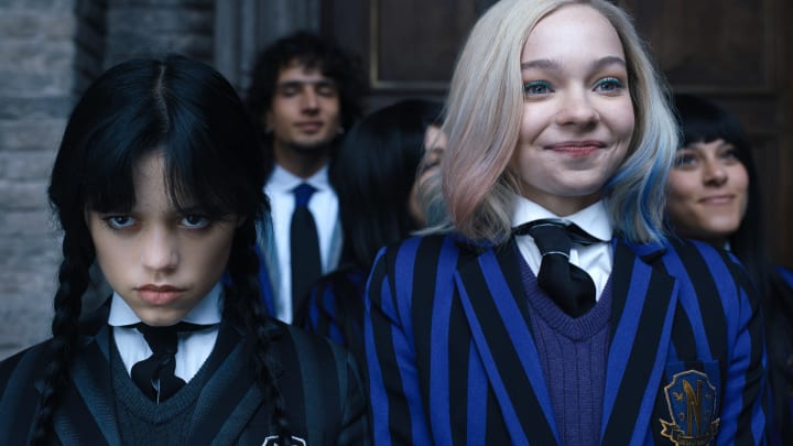 Wednesday. (L to R) Jenna Ortega as Wednesday Addams, Emma Myers as Enid Sinclair in episode 102 of Wednesday. Cr. Courtesy of Netflix © 2022