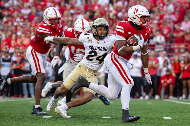 Nebraska running back Dante Dowdell takes off on a 12-yard touchdown run in the first quarter against Colorado.