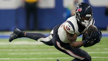 Houston Texans wide receiver Nico Collins (12) makes a sliding catch Saturday, Jan. 6, 2024, during a game against the Indianapolis Colts at Lucas Oil Stadium in Indianapolis.