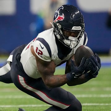 Houston Texans wide receiver Nico Collins (12) makes a sliding catch Saturday, Jan. 6, 2024, during a game against the Indianapolis Colts at Lucas Oil Stadium in Indianapolis.