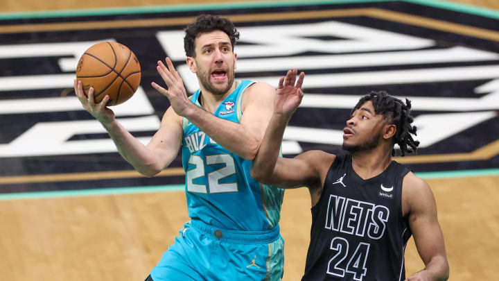 Mar 9, 2024; Charlotte, North Carolina, USA;  Charlotte Hornets guard Vasa Micic (22) goes to the basket against Brooklyn Nets guard Cam Thomas (24) during the fourth quarter at Spectrum Center. Mandatory Credit: Cory Knowlton-USA TODAY Sports