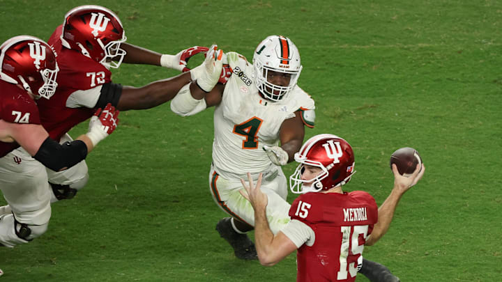 Jan 19, 2026; Miami Gardens, FL, USA; Indiana Hoosiers quarterback Fernando Mendoza (15) passes the ball under pressure by Miami Hurricanes defensive lineman Rueben Bain Jr. (4) in the third quarter during the College Football Playoff National Championship game at Hard Rock Stadium. Mandatory Credit: Kim Klement Neitzel-Imagn Images