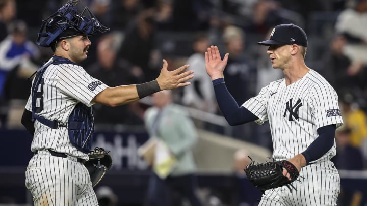 Apr 24, 2024; Bronx, New York, USA; New York Yankees relief pitcher Ian Hamilton (71) and catcher Austin Wells (28) congratulate each other after defeating the Oakland Athletics at Yankee Stadium. Mandatory Credit: Wendell Cruz-USA TODAY Sports