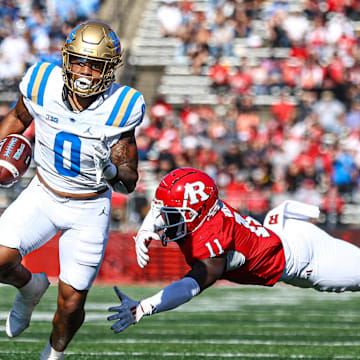 Oct 19, 2024; Piscataway, New Jersey, USA;  UCLA Bruins running back Jalen Berger (0) catches a pass for a touchdown as Rutgers Scarlet Knights linebacker Abram Wright (11) pursues during the second half at SHI Stadium. Mandatory Credit: Vincent Carchietta-Imagn Images