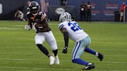 Luther Burden III looks for catch-and-run action against Dallas safety Malik Hooker in the Bears' Week 3 win.