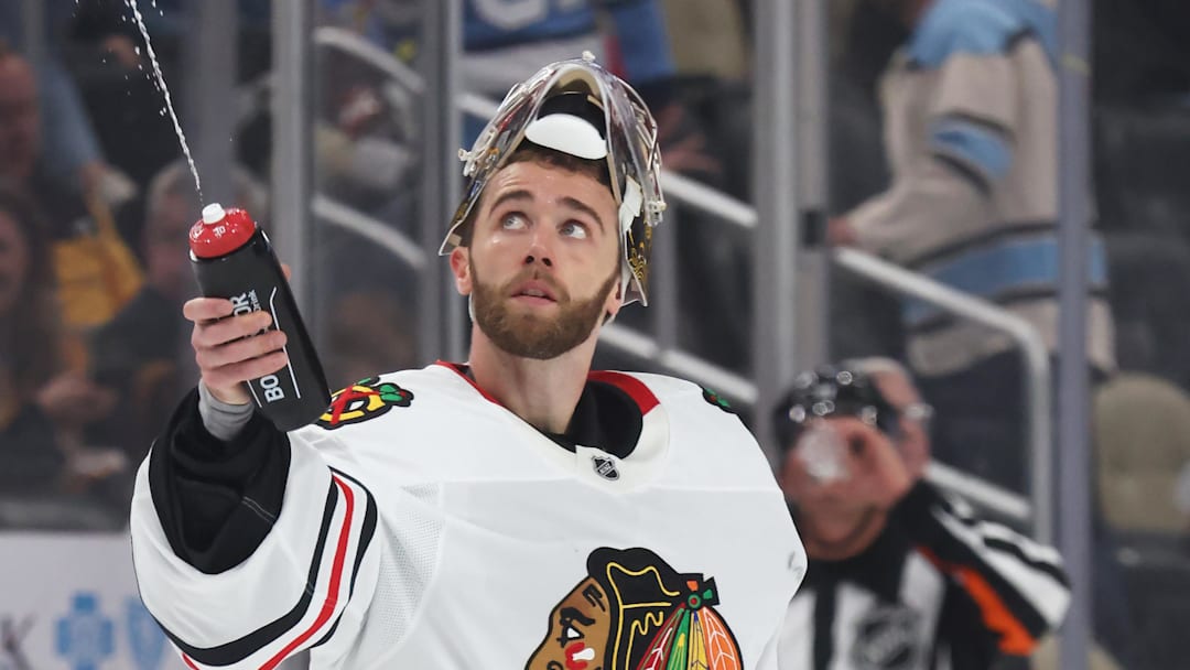 Apr 8, 2025; Pittsburgh, Pennsylvania, USA;  Chicago Blackhawks goaltender Spencer Knight (30) squirts water during a time-out against the Pittsburgh Penguins in the third period at PPG Paints Arena. Mandatory Credit: Charles LeClaire-Imagn Images