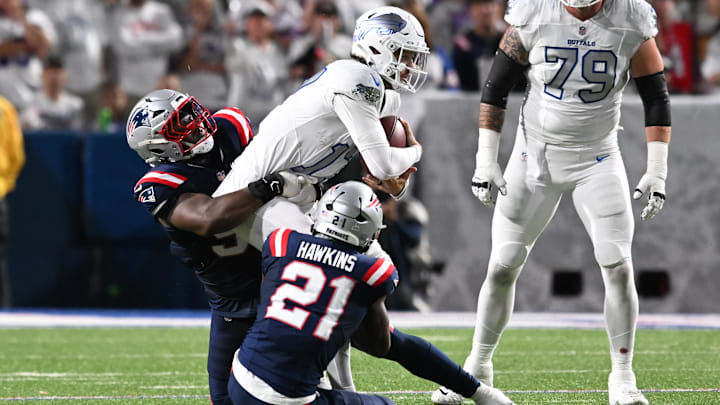Oct 5, 2025; Orchard Park, New York, USA; Buffalo Bills quarterback Josh Allen (17) is tackled by New England Patriots safety Jaylinn Hawkins (21) during the first half