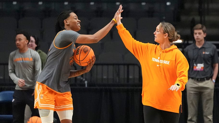 Tennessee's Zee Spearman (11) and Tennessee basketball coach Kim Caldwell slap hands at practice