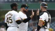 Jul 24, 2024; Pittsburgh, Pennsylvania, USA;  Pittsburgh Pirates relief pitcher Aroldis Chapman (45) and first baseman Rowdy Tellez (middle) and catcher Joey Bart (14)  celebrate after defeating the St. Louis Cardinals at PNC Park. Pittsburgh won 5-0. Mandatory Credit: Charles LeClaire-USA TODAY Sports