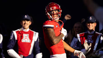 Nov 30, 2024; Tucson, Arizona, USA; Arizona Wildcats wide receiver Tetairoa McMillan (4) celebrates a touchdown against the Arizona State Sun Devils in the second half during the Territorial Cup at Arizona Stadium. Mandatory Credit: Mark J. Rebilas-Imagn Images