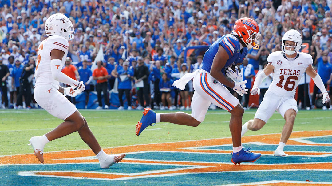 Oct 4, 2025; Gainesville, Florida, USA; Florida Gators wide receiver Dallas Wilson (6) makes a catch for a touchdown while Texas Longhorns defensive backs Kobe Black (6) and Michael Taaffe (16) watch.