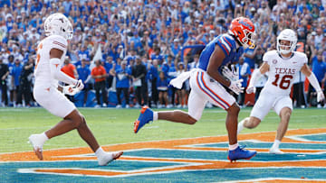 Oct 4, 2025; Gainesville, Florida, USA; Florida Gators wide receiver Dallas Wilson (6) makes a catch for a touchdown while Texas Longhorns defensive backs Kobe Black (6) and Michael Taaffe (16) watch.
