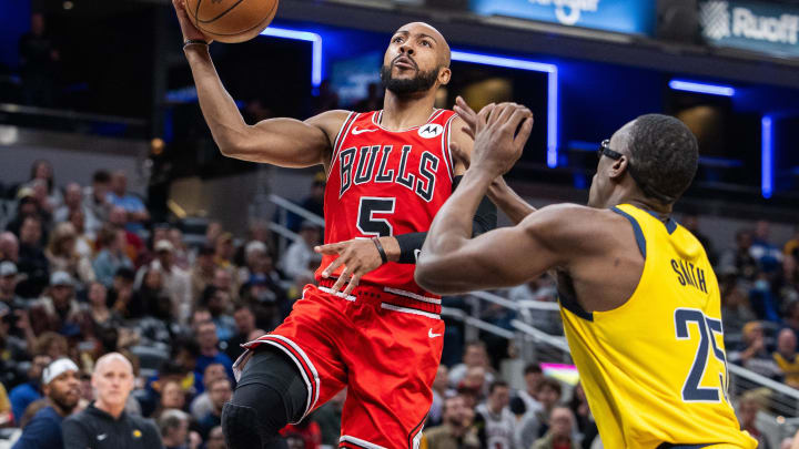 Oct 30, 2023; Indianapolis, Indiana, USA; Chicago Bulls guard Jevon Carter (5) shoots the ball while Indiana Pacers forward Jalen Smith (25) defends in the first quarter at Gainbridge Fieldhouse. Mandatory Credit: Trevor Ruszkowski-USA TODAY Sports