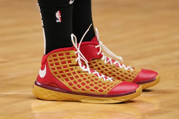 P.J. Tucker wears red and gold Nike Kobe sneakers.