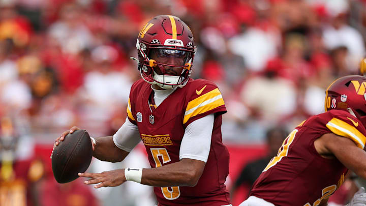 Sep 8, 2024; Tampa, Florida, USA; Washington Commanders quarterback Jayden Daniels (5) drops back to pass against the Tampa Bay Buccaneers in the third quarter at Raymond James Stadium.  