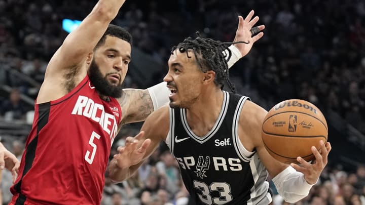 Mar 12, 2024; San Antonio, Texas, USA; San Antonio Spurs guard Tre Jones (33) drives to the basket while defended by Houston Rockets guard Fred VanVleet (5) during the second half at Frost Bank Center. Mandatory Credit: Scott Wachter-USA TODAY Sports