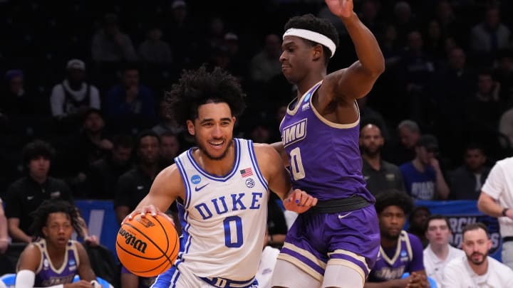 Mar 24, 2024; Brooklyn, NY, USA; Duke Blue Devils guard Jared McCain (0) dribbles the ball past James Madison Dukes guard Xavier Brown (0) in the second round of the 2024 NCAA Tournament  at Barclays Center. Mandatory Credit: Robert Deutsch-USA TODAY Sports