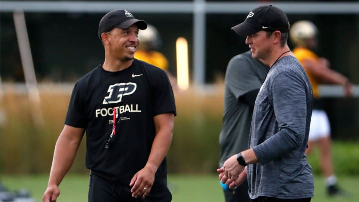 Purdue coach Ryan Walters talks to defensive coordinator Kevin Kane