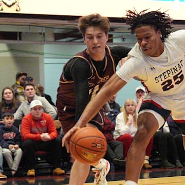 Stepinac's Jasiah Jervis (25) and Iona's Joe Wolf (11) battle for a loose ball during the Crusader Classic at the Westchester County Center in White Plains Jan. 4, 2025.