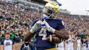 Nov 22, 2025; South Bend, Indiana, USA; Notre Dame Fighting Irish running back Jeremiyah Love (4) celebrates scoring against the Syracuse Orange during the first half at Notre Dame Stadium. 