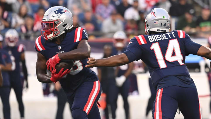 Aug 15, 2024; Foxborough, MA, USA; New England Patriots quarterback Jacoby Brissett (14) hands the ball to running back Rhamondre Stevenson (38) during the first half at Gillette Stadium. Mandatory Credit: Eric Canha-USA TODAY Sports